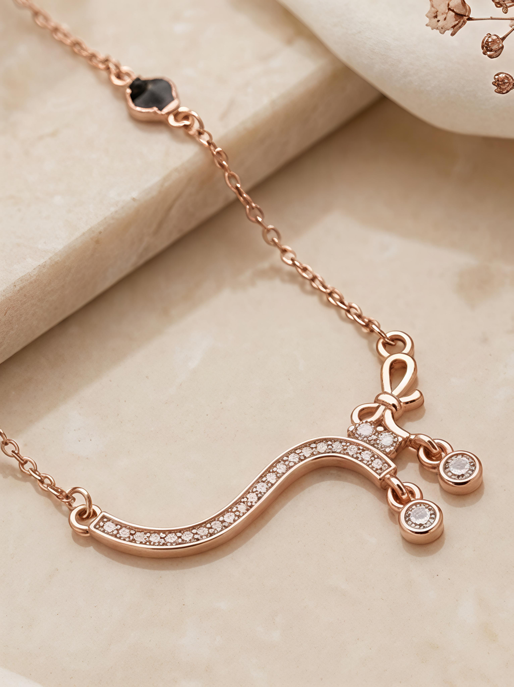 Rose Gold Curved Crystal Wave Necklace with Black Bead Accents